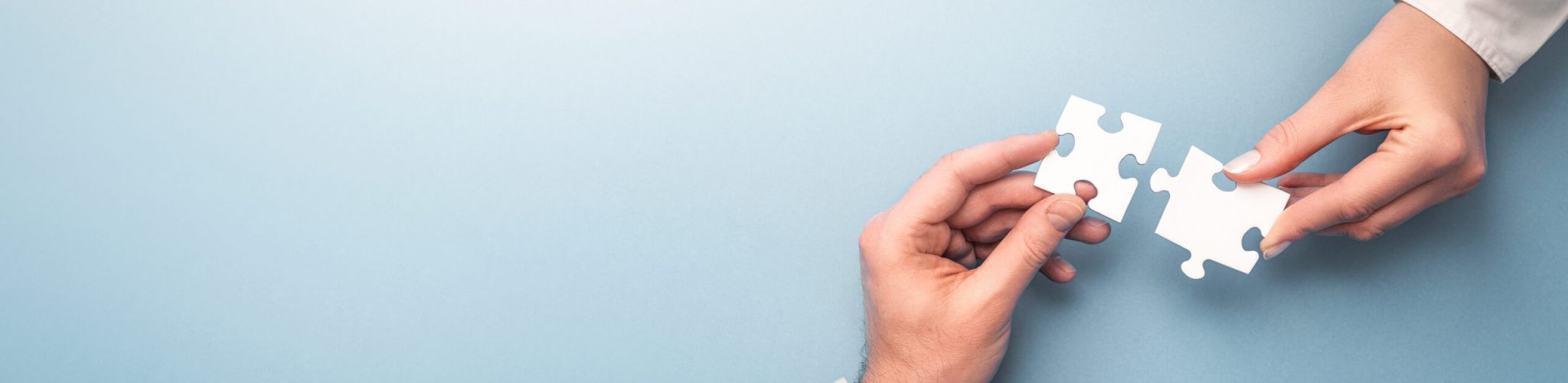 People holds in hand a jigsaw puzzle. Business solutions, success and strategy. The man and woman holds in hand a jigsaw puzzle. Business solutions, success and strategy concept.